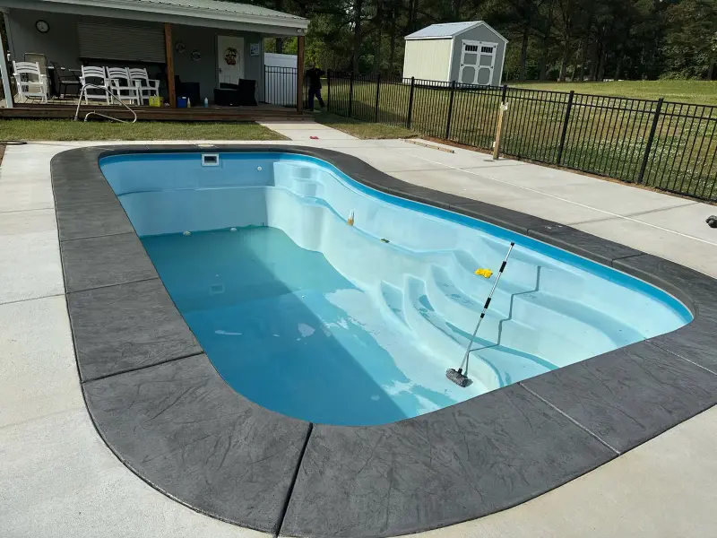 North Carolina Custom Pools Gallery: pool with stamped concrete patio in a residential backyard