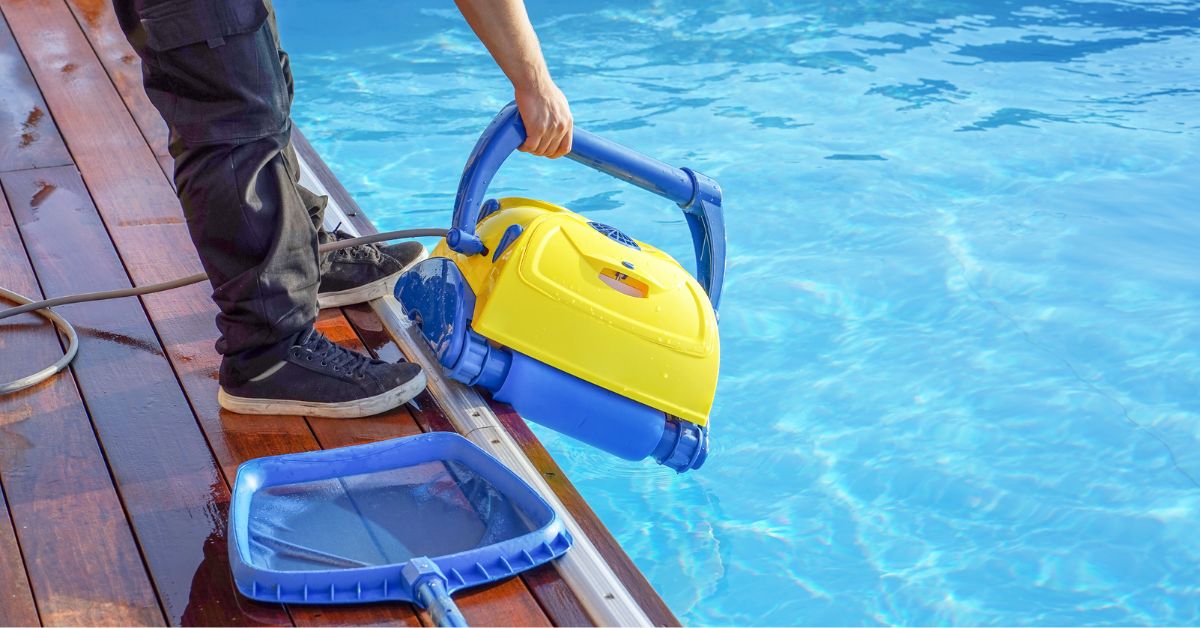 swimming pool contractor cleaning a pool